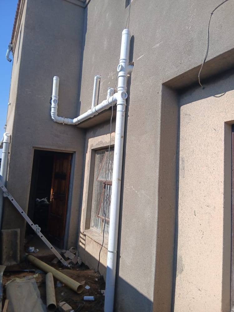 New PVC soil and waste stack installed on the outside of a double-storey home