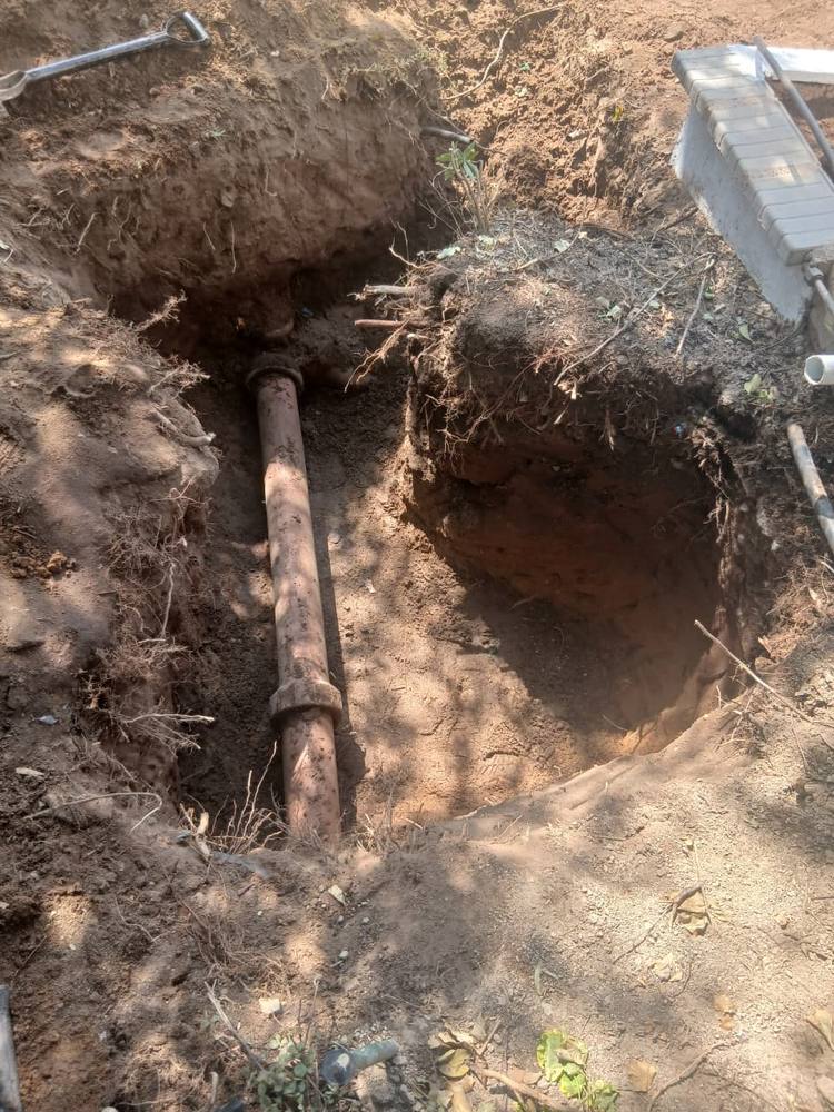 Excavated trench exposing a failed water main during an emergency call-out