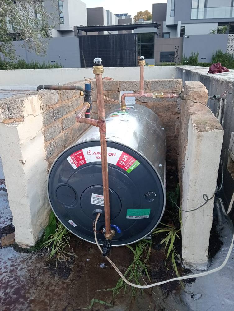 New geyser installed in an outdoor alcove with copper pipework and isolating valves