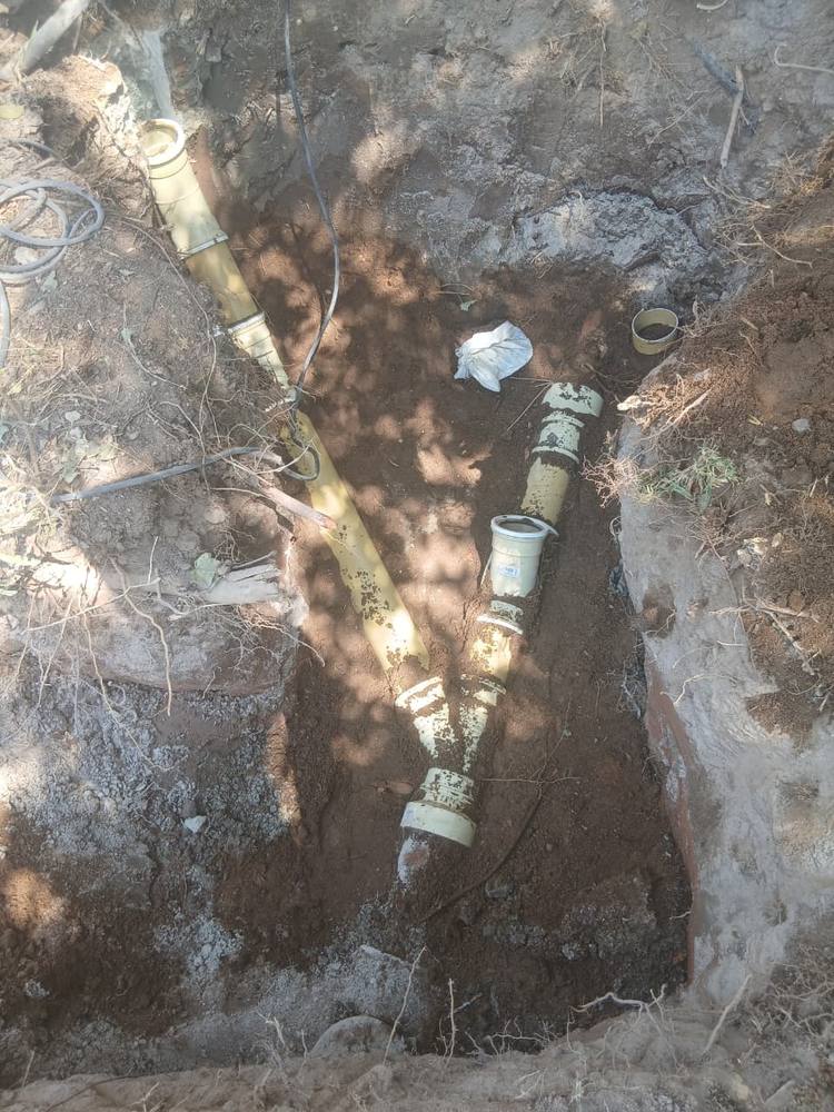 Old galvanised water pipe exposed in a trench ready for replacement