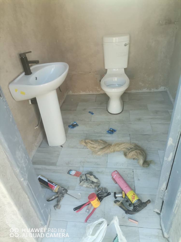 Toilet and pedestal basin installed and connected in a new bathroom