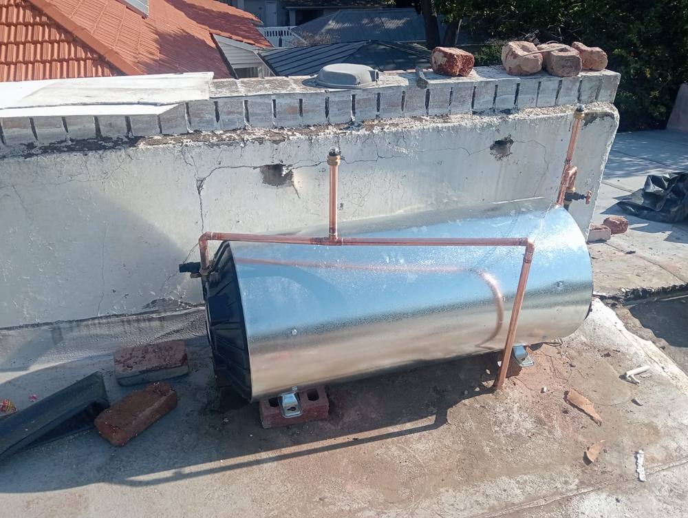 Geyser mounted and plumbed on a roof with insulated pipework