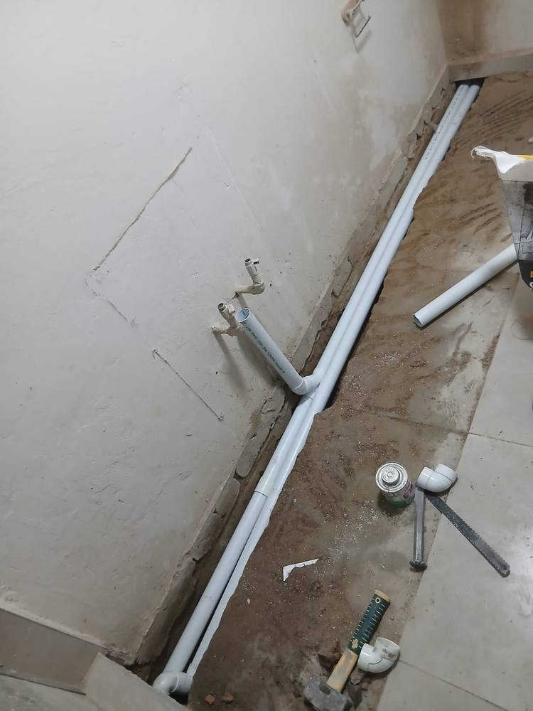 New water reticulation pipework run neatly along a wall before the floor screed